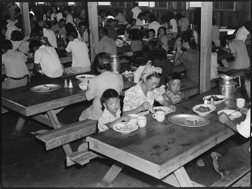 Manzanar Relocation Center, Manzanar, California. Mealtime in one of the messhalls at this War Relocation Authority center for evacuees of Japanese ancestry.